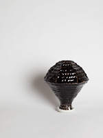coiled porcelain vase with tenmoku glaze and sand base
